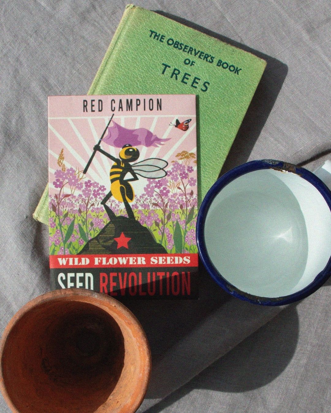 A vintage style wildflower red campion seed packet with gardening bits on a grey background. Showcasing Seed Revolution's Silene dioica, red campion plant, Silene dioica red campion, red campion Silene dioica, Silene red campion, british wild flower seeds, british wildflower seeds, uk wildflower seeds.